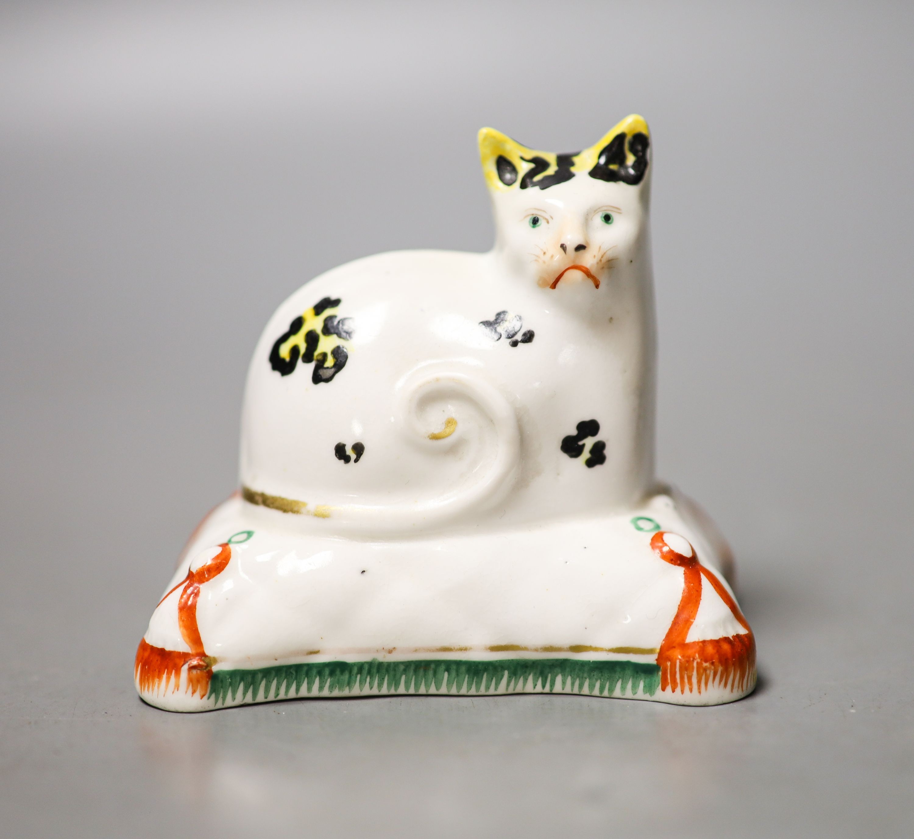 A Staffordshire porcelain model of a cat seated on a cushion, c.1835–50